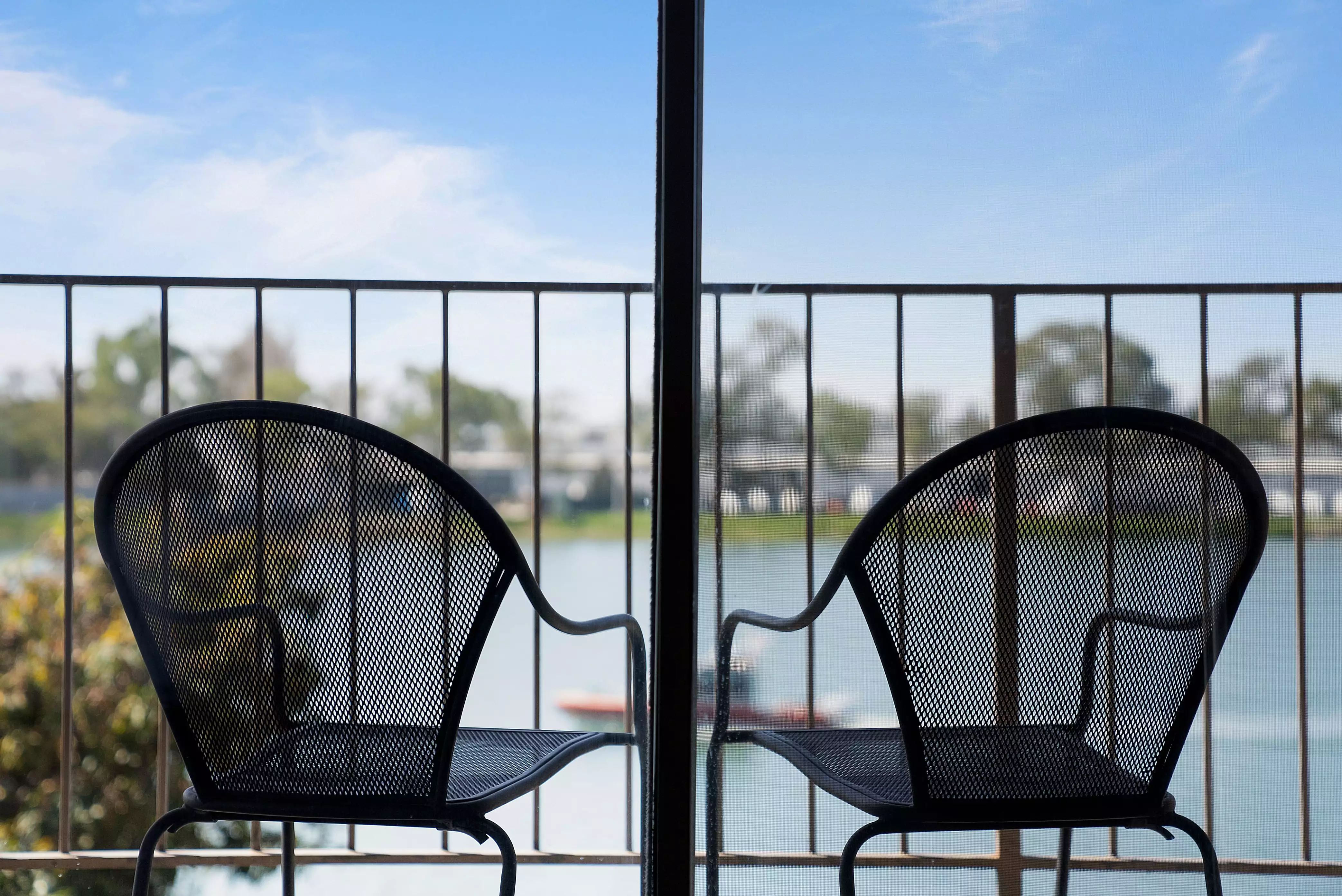 Two chairs on a balcony in a room at Executive Inn & Suites - Embarcadero Cove