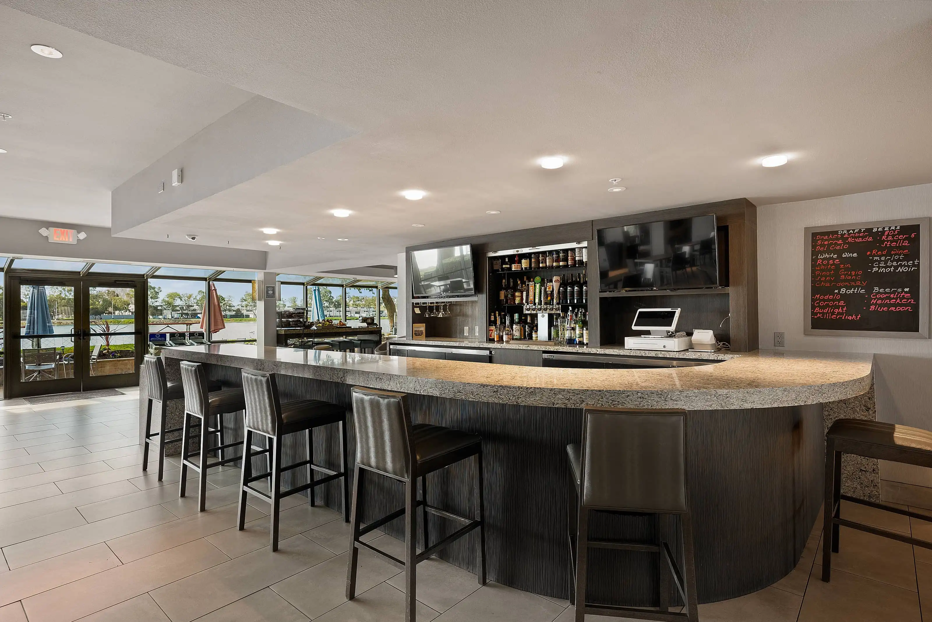 The Lounge at Executive Inn & Suites - Embarcadero Cove showing the bar and menu items available